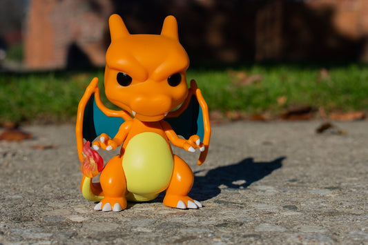 an orange toy sitting on top of a cement ground